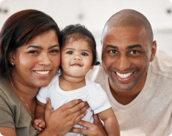 parents holding a young child